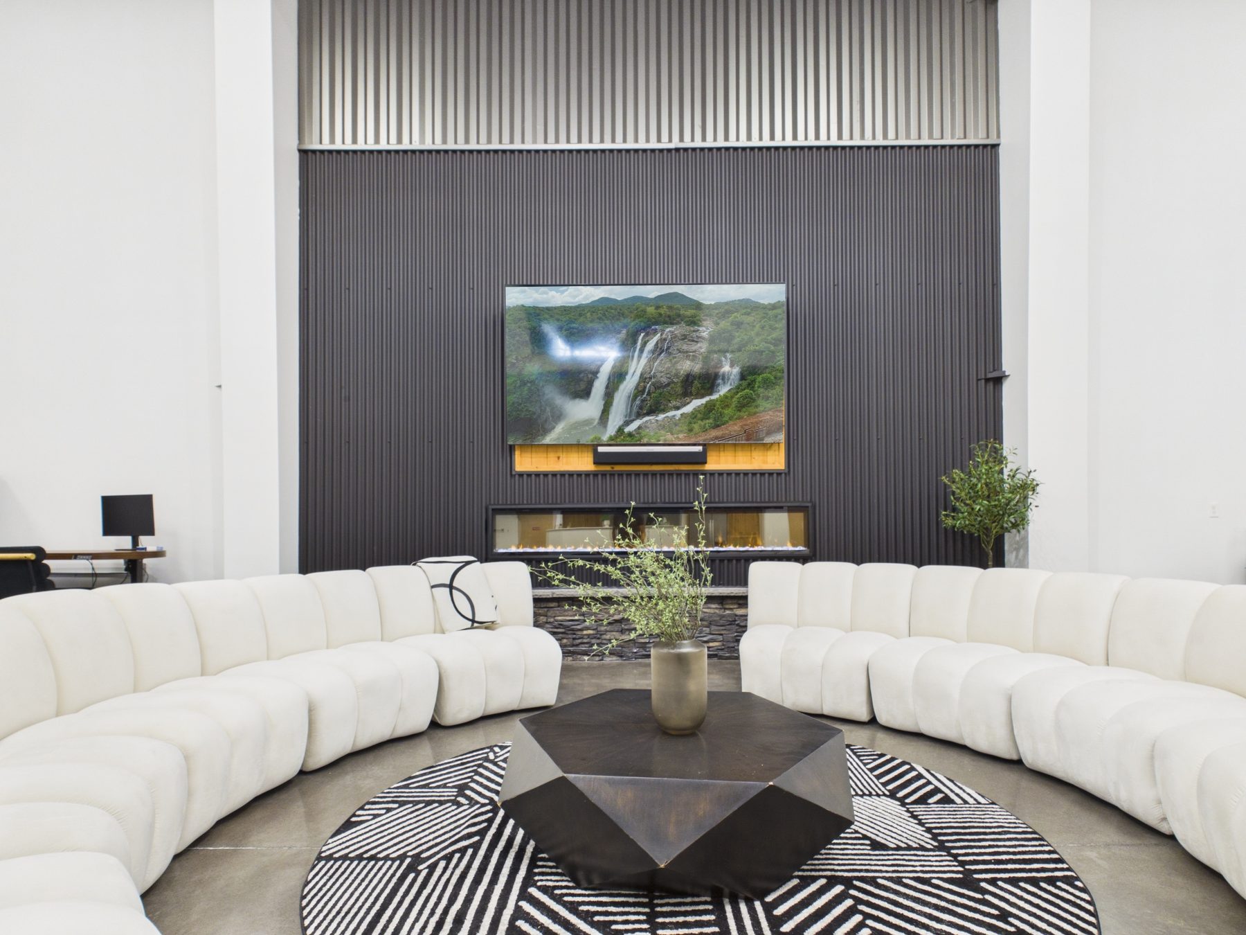 Members lounge with curved seating and feature wall