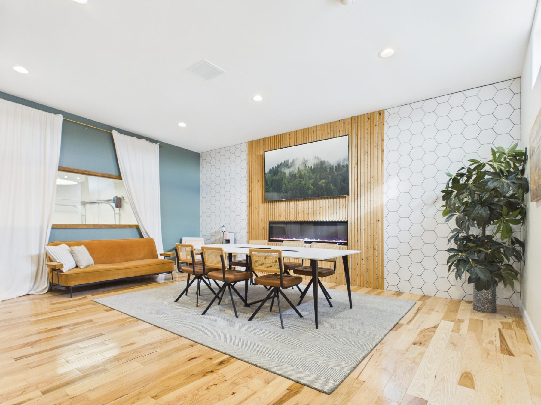 Bright private office suite with fireplace wall and long table