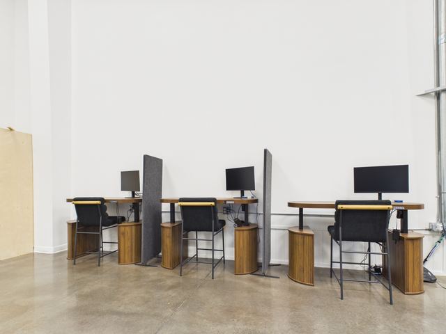 Standing-height desks with monitors