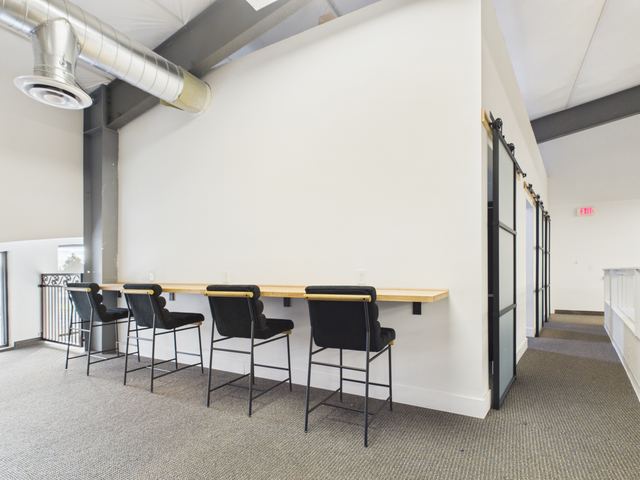 Counter-height desks along the upper level